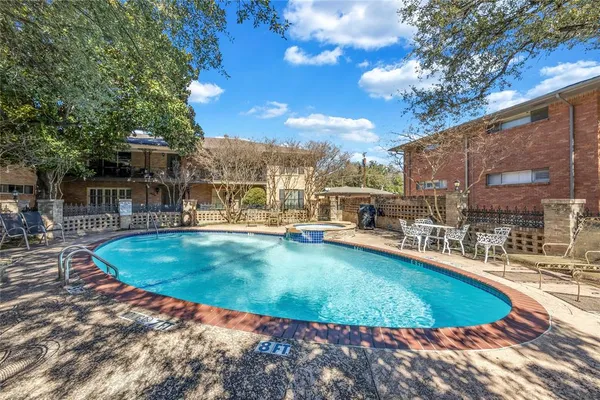 a view of a swimming pool with outdoor seating