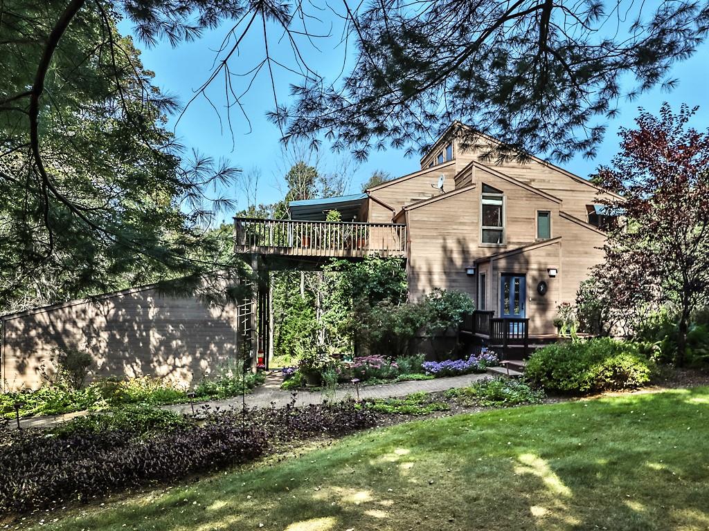 a front view of a house with a yard and tree s
