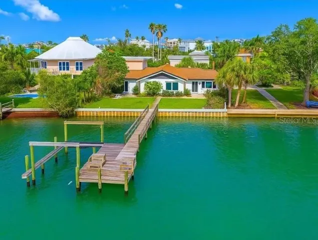 an aerial view of a house with swimming pool garden view and trees