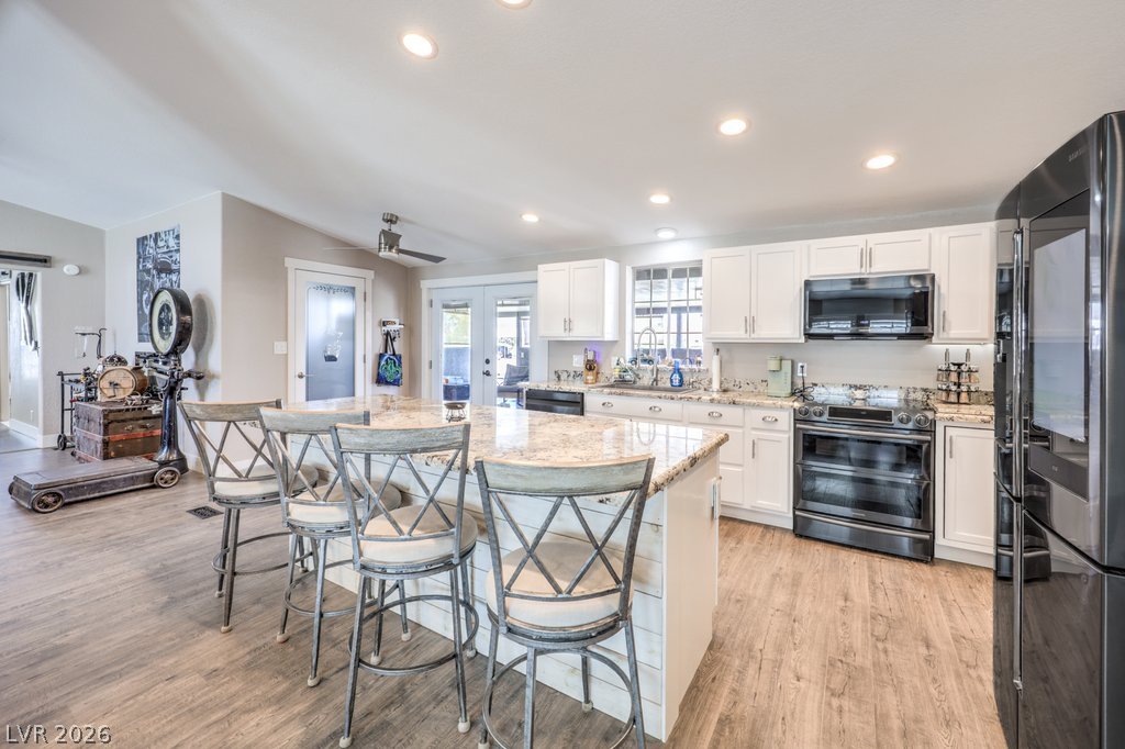 4375 Pinwheel Street Logandale, NV 89021 - Photo 11 of 52 A grand granite island with bar seating anchors this inviting kitchen, perfect for casual dining and entertaining.