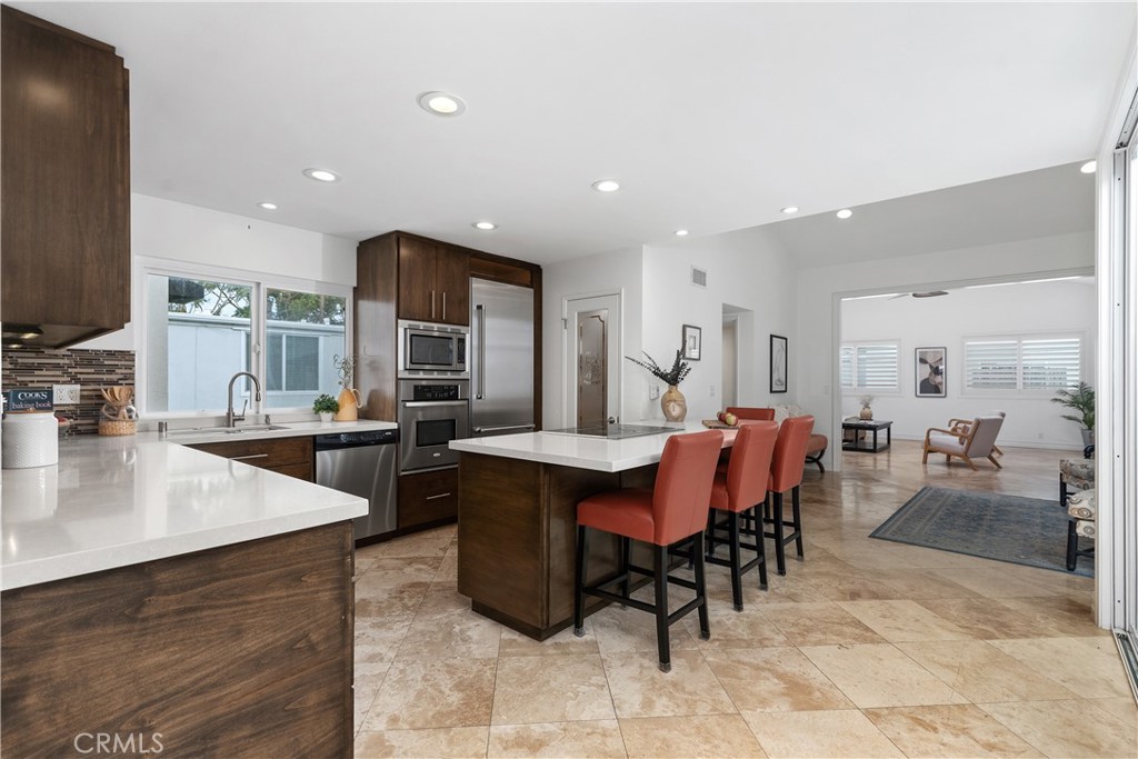154 12th Street Seal Beach, CA 90740 - Photo 16 of 39 a large kitchen with a table and chairs