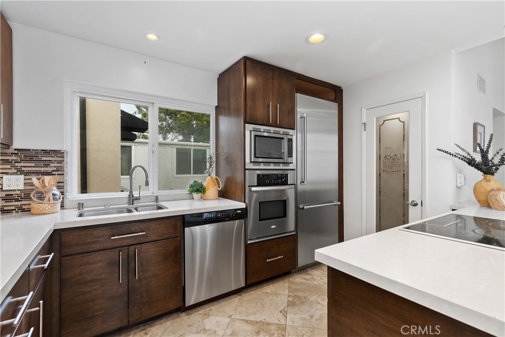154 12th Street Seal Beach, CA 90740 - Photo 18 of 39 a kitchen with a sink stainless steel appliances and counter space