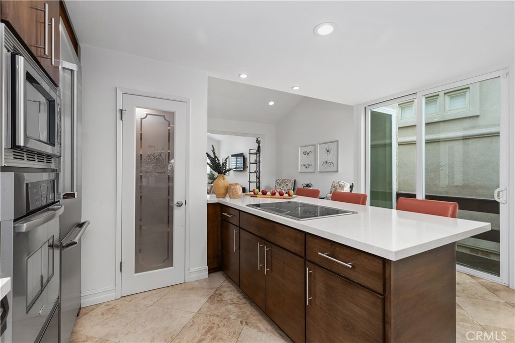 154 12th Street Seal Beach, CA 90740 - Photo 19 of 39 a kitchen with a sink stove and refrigerator