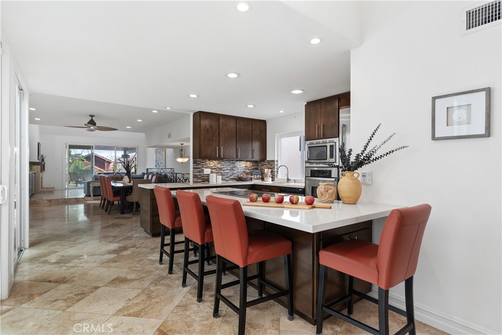 154 12th Street Seal Beach, CA 90740 - Photo 20 of 39 a dining room with stainless steel appliances a table and chairs