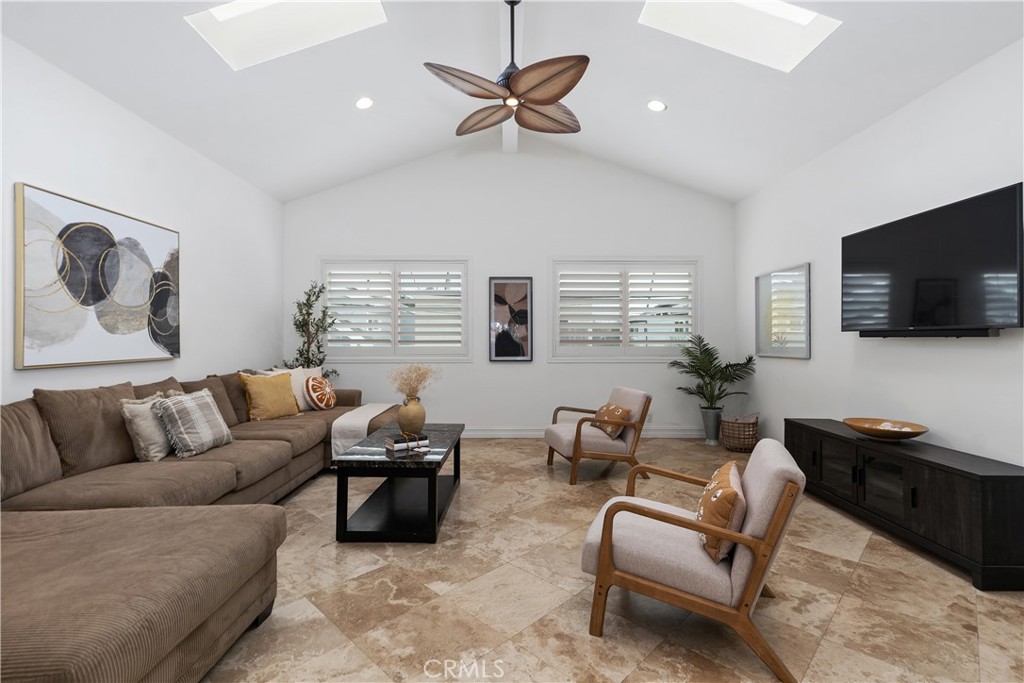 154 12th Street Seal Beach, CA 90740 - Photo 24 of 39 a living room with furniture ceiling fan and a window