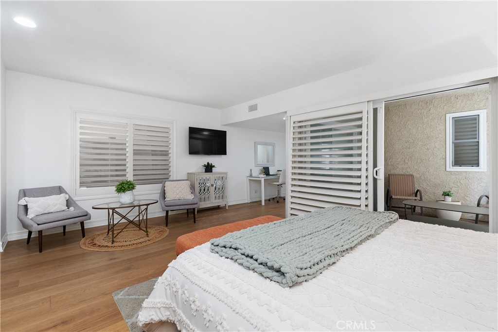 154 12th Street Seal Beach, CA 90740 - Photo 30 of 39 a bedroom with a bed a large window and a couch