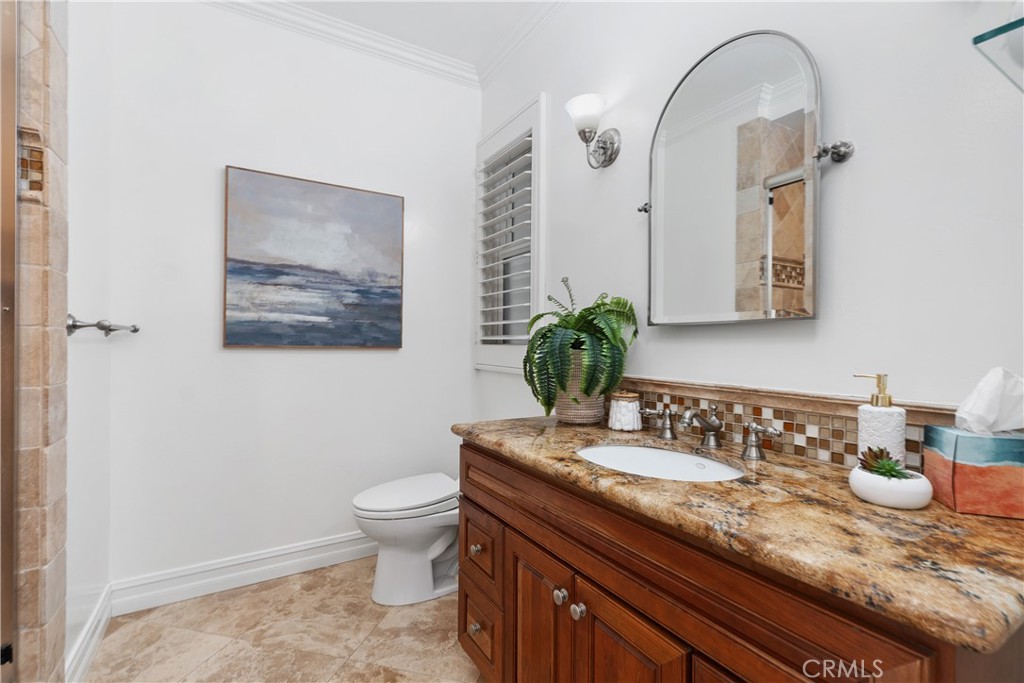 154 12th Street Seal Beach, CA 90740 - Photo 32 of 39 a bathroom with a granite countertop sink and a mirror