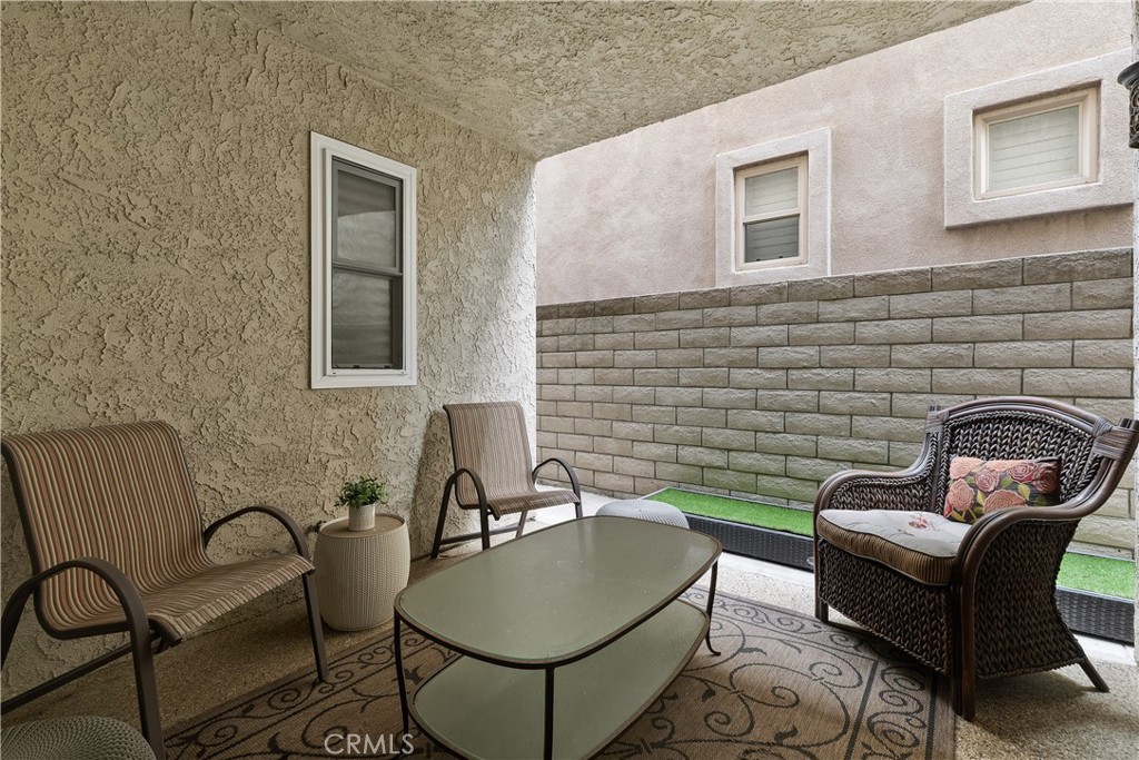 154 12th Street Seal Beach, CA 90740 - Photo 34 of 39 a backyard of a house with fire pit and furniture