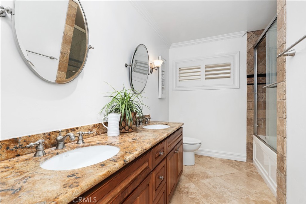 154 12th Street Seal Beach, CA 90740 - Photo 37 of 39 a bathroom with a granite countertop sink a mirror and a shower