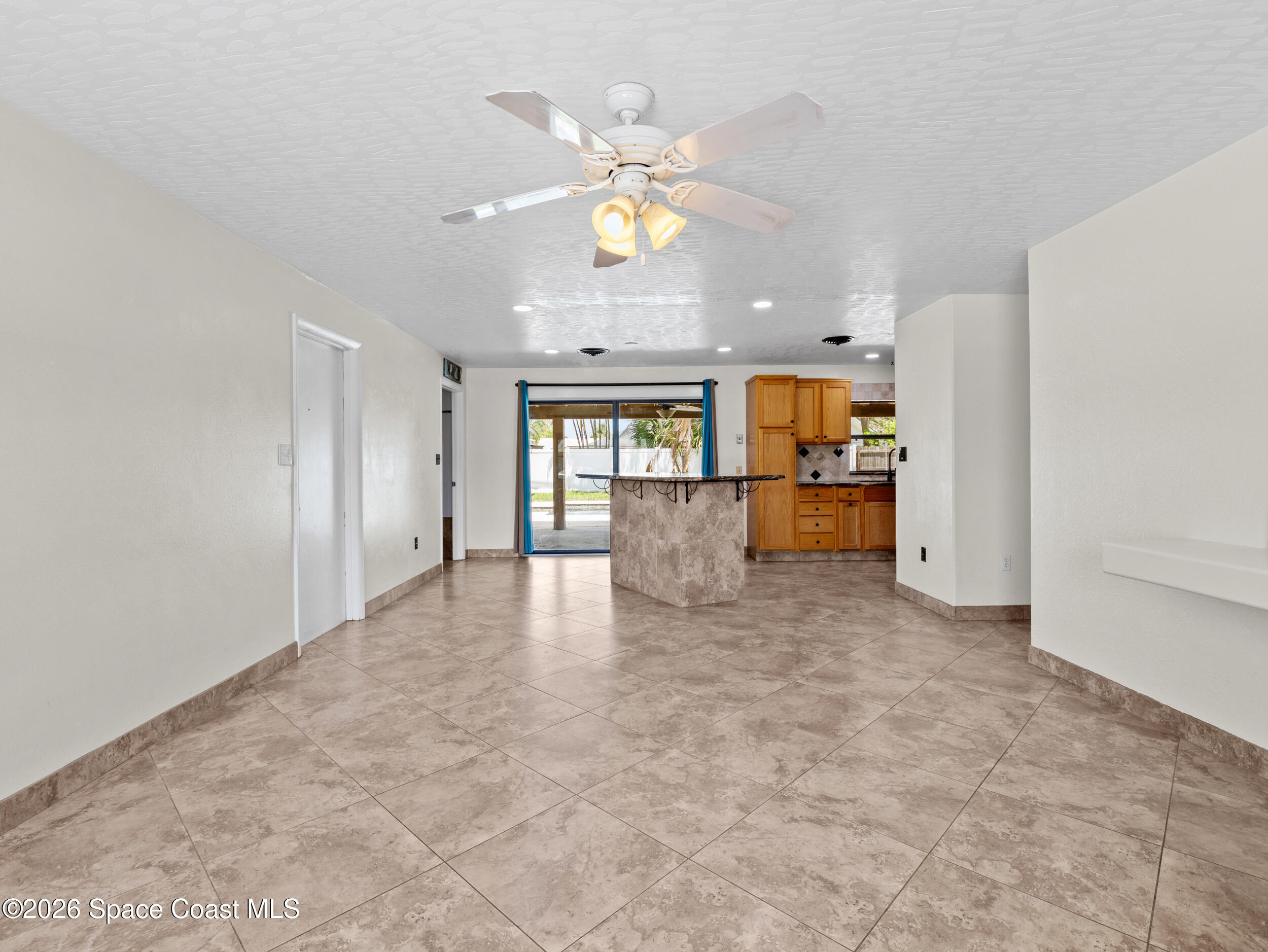 406 Amherst Avenue Melbourne, FL 32901 - Photo 13 of 36 a view of an empty room with a kitchen