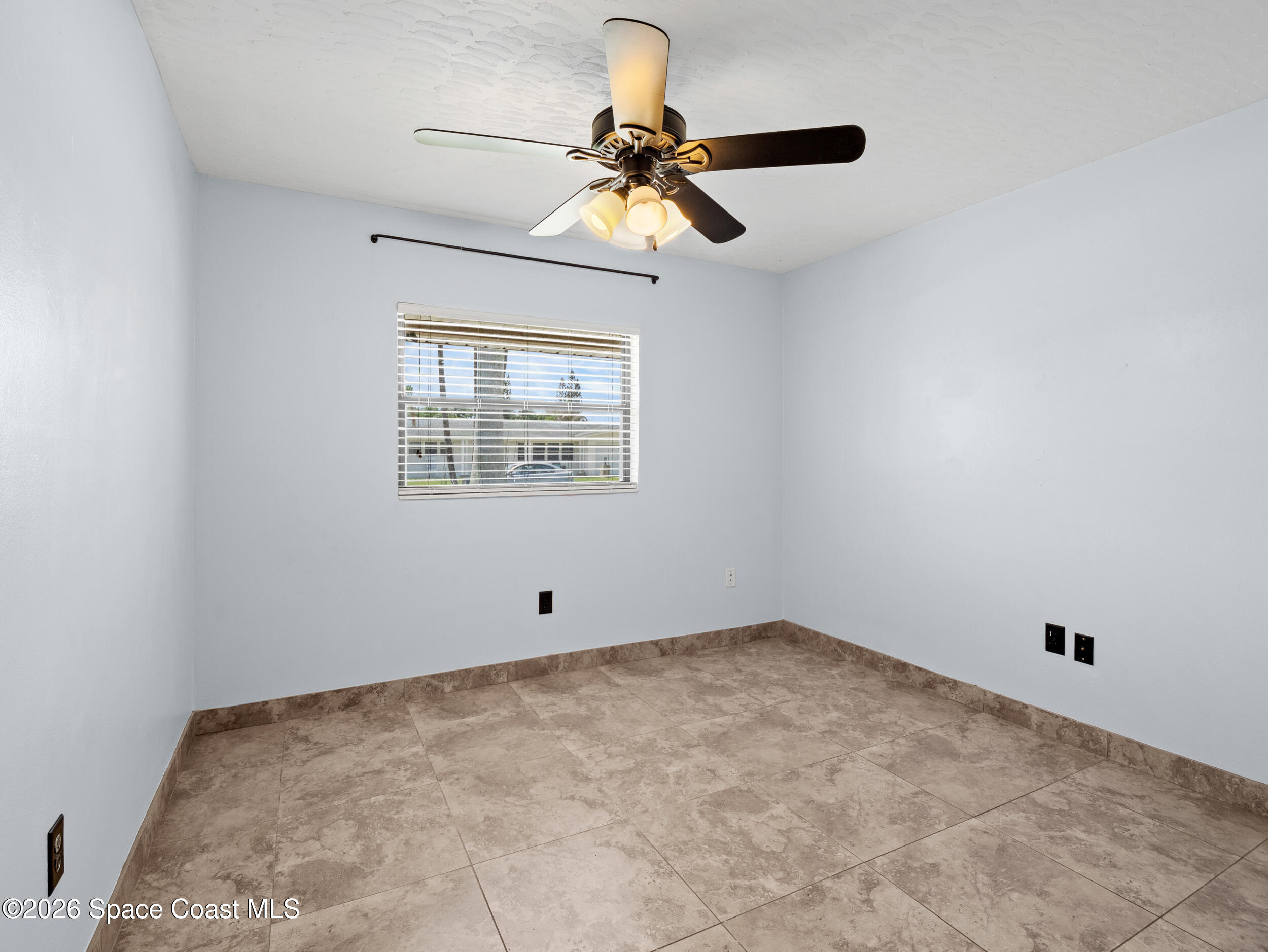 406 Amherst Avenue Melbourne, FL 32901 - Photo 18 of 36 a view of room with a ceiling fan and window