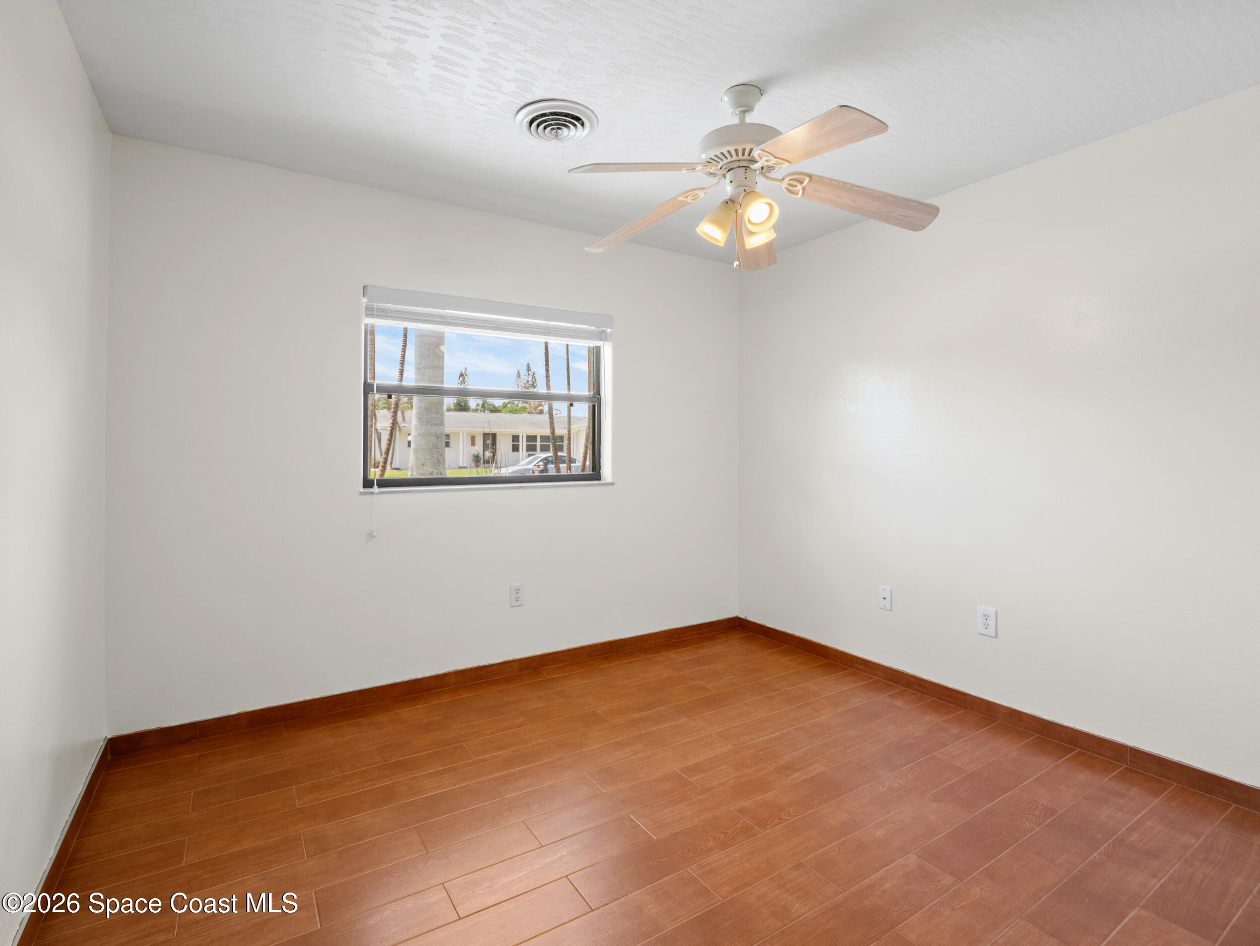 406 Amherst Avenue Melbourne, FL 32901 - Photo 20 of 36 an empty room with a window and a fan