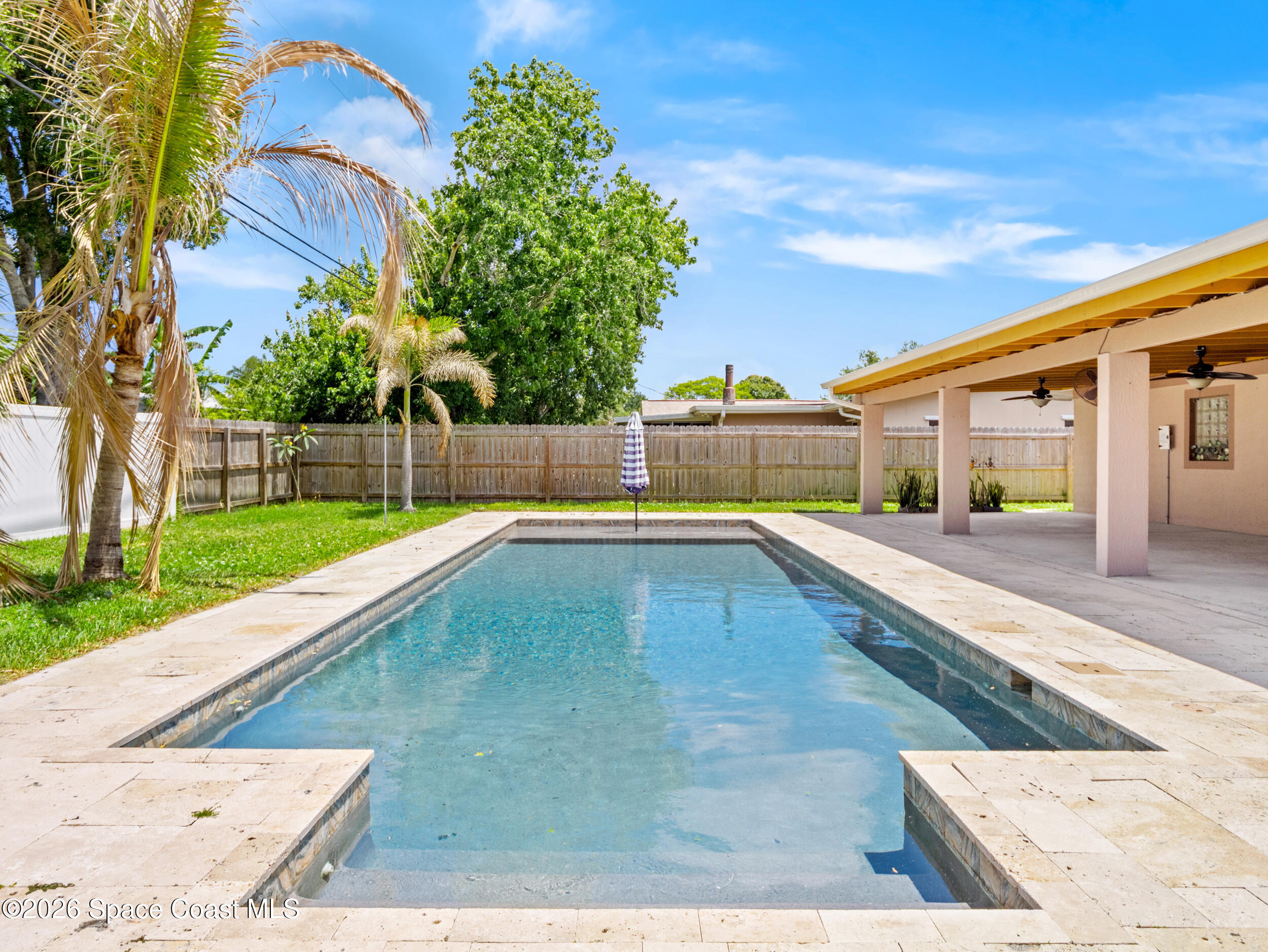 406 Amherst Avenue Melbourne, FL 32901 - Photo 28 of 36 a swimming pool with some trees in the background