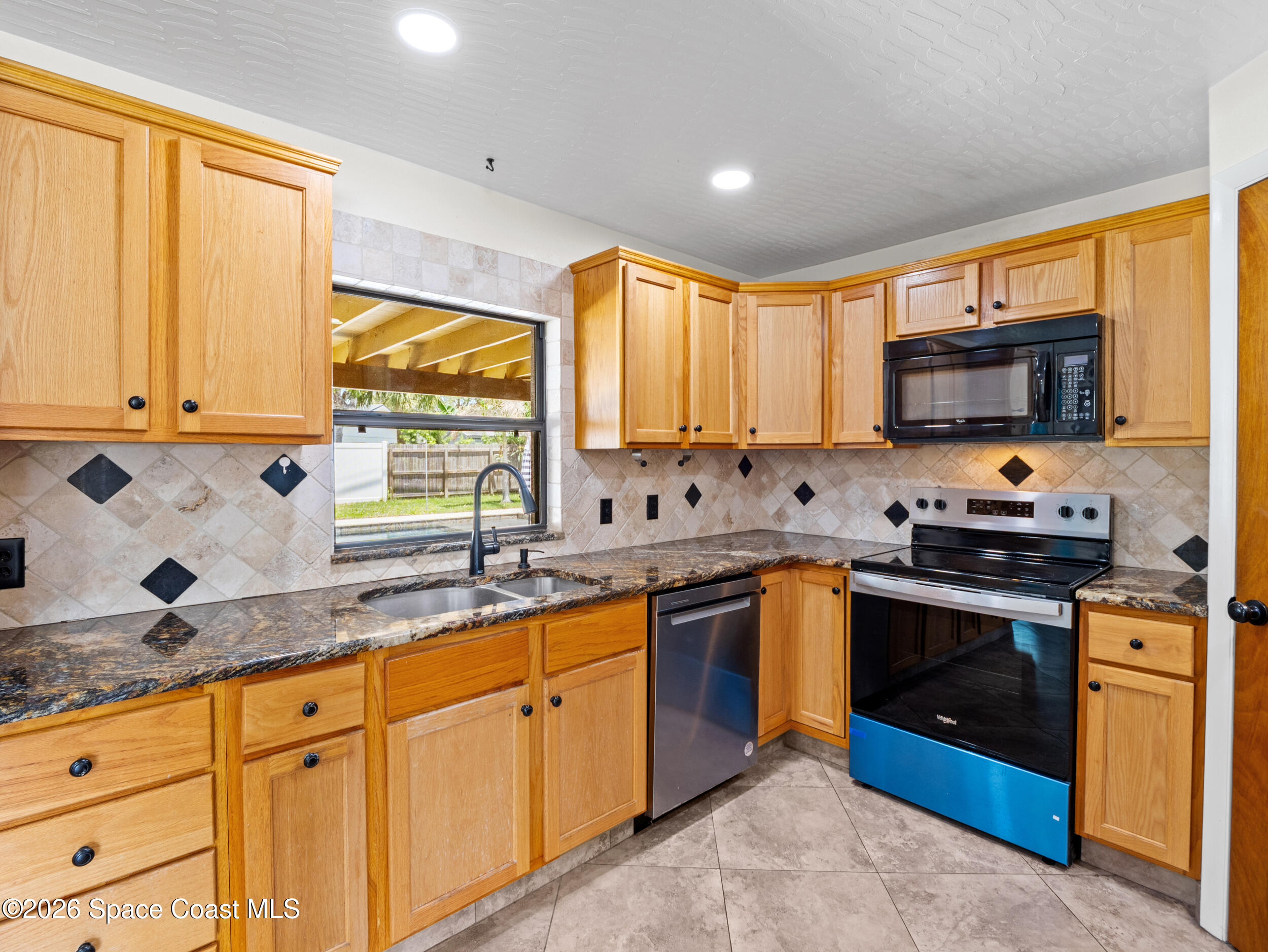 406 Amherst Avenue Melbourne, FL 32901 - Photo 4 of 36 a kitchen with stainless steel appliances granite countertop a stove sink and cabinets