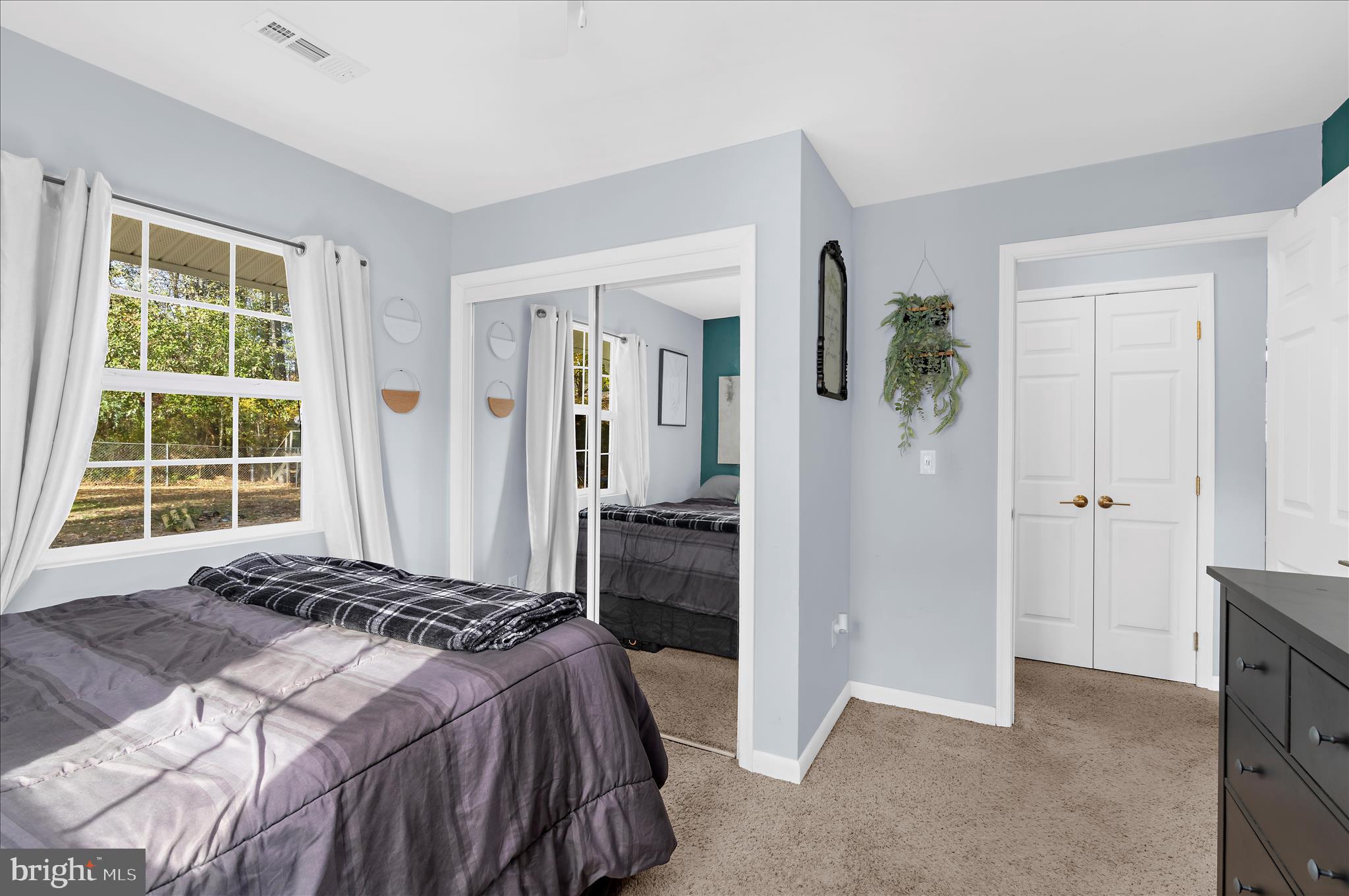 29885 Washington Road Mechanicsville, MD 20659 - Photo 13 of 32 a bedroom with a bed and a window