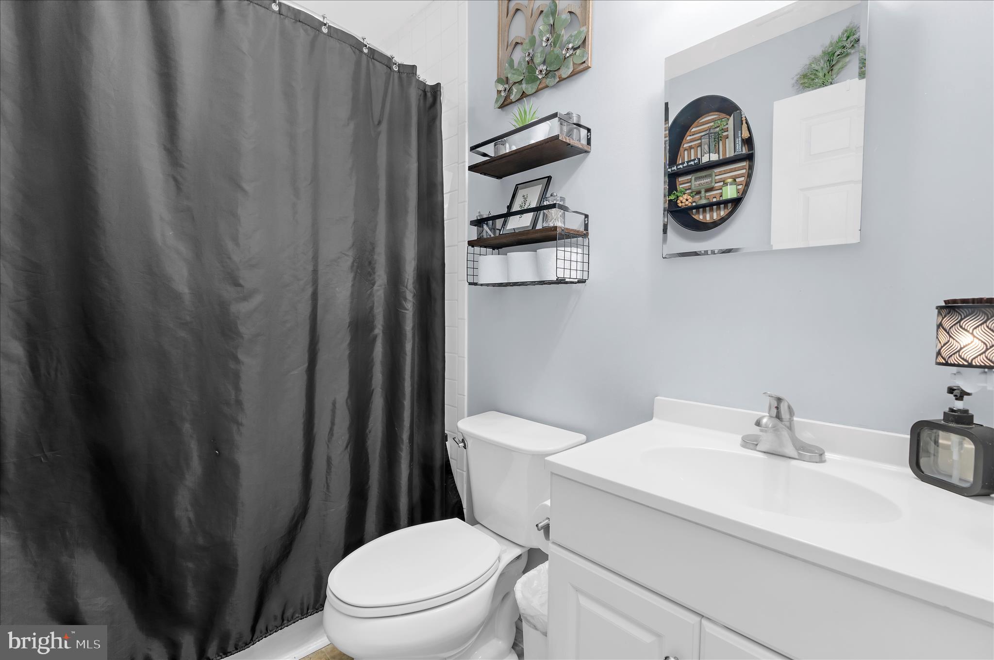 29885 Washington Road Mechanicsville, MD 20659 - Photo 14 of 32 a white toilet sitting next to a bathroom sink