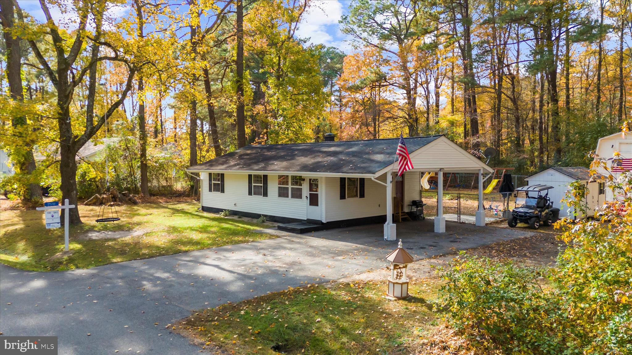 29885 Washington Road Mechanicsville, MD 20659 - Photo 22 of 32 a backyard of a house with swimming pool and large trees
