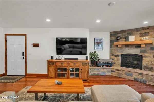 a living room with furniture kitchen view and a large window
