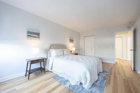a bedroom with a bed and a table