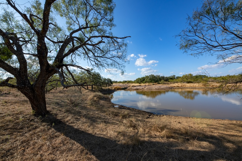 Undisclosed Address Rocksprings, TX 78880 - Photo 7 of 12 a view of a lake with houses in the back