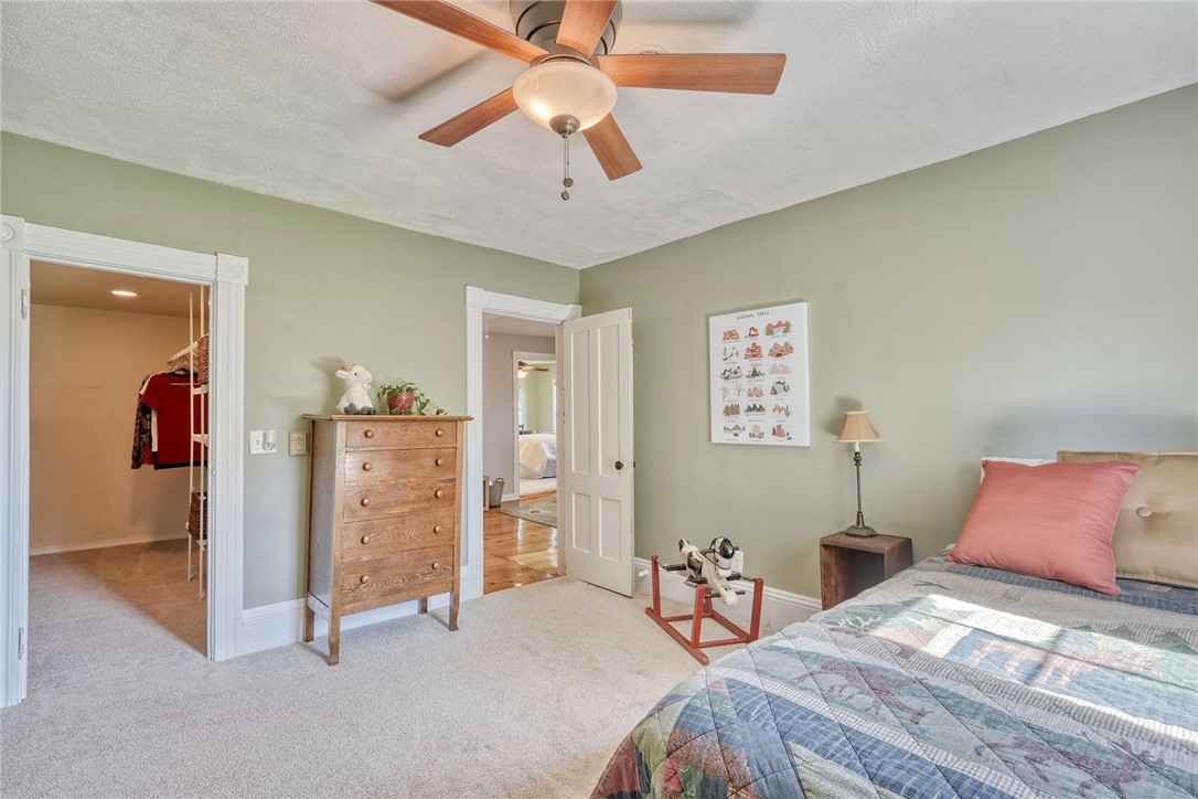 956 Willits Road Ontario, NY 14519 - Photo 33 of 50 Bedroom with exposed brick and beams and a huge wa