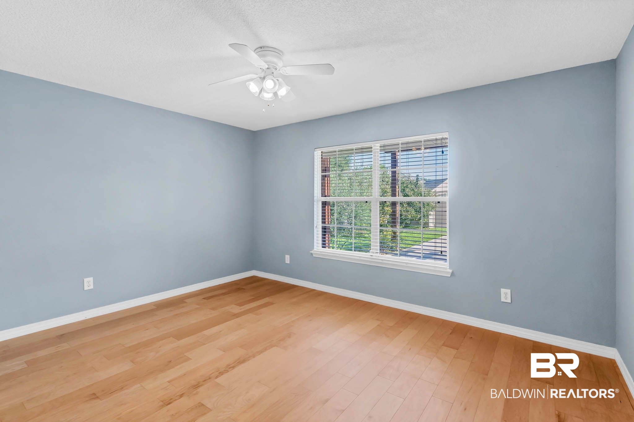 9607 Czar Court Fairhope, AL 36532 - Photo 23 of 42 Empty room with wood finished floors, a textured ceiling, and a ceiling fan