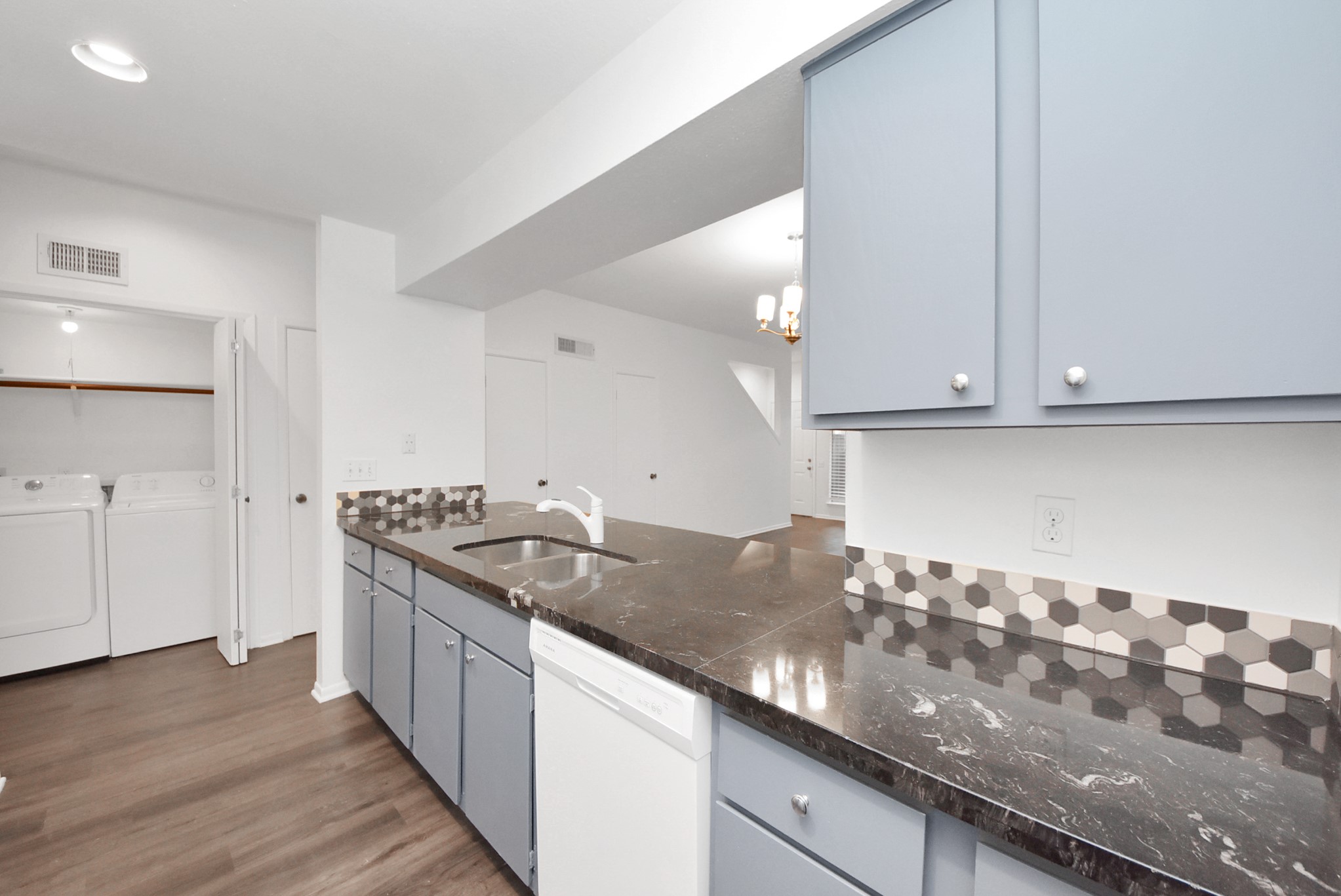 1635 Prairie Mark Lane Houston, TX 77077 - Photo 17 of 32 a kitchen with granite countertop a sink and a stove