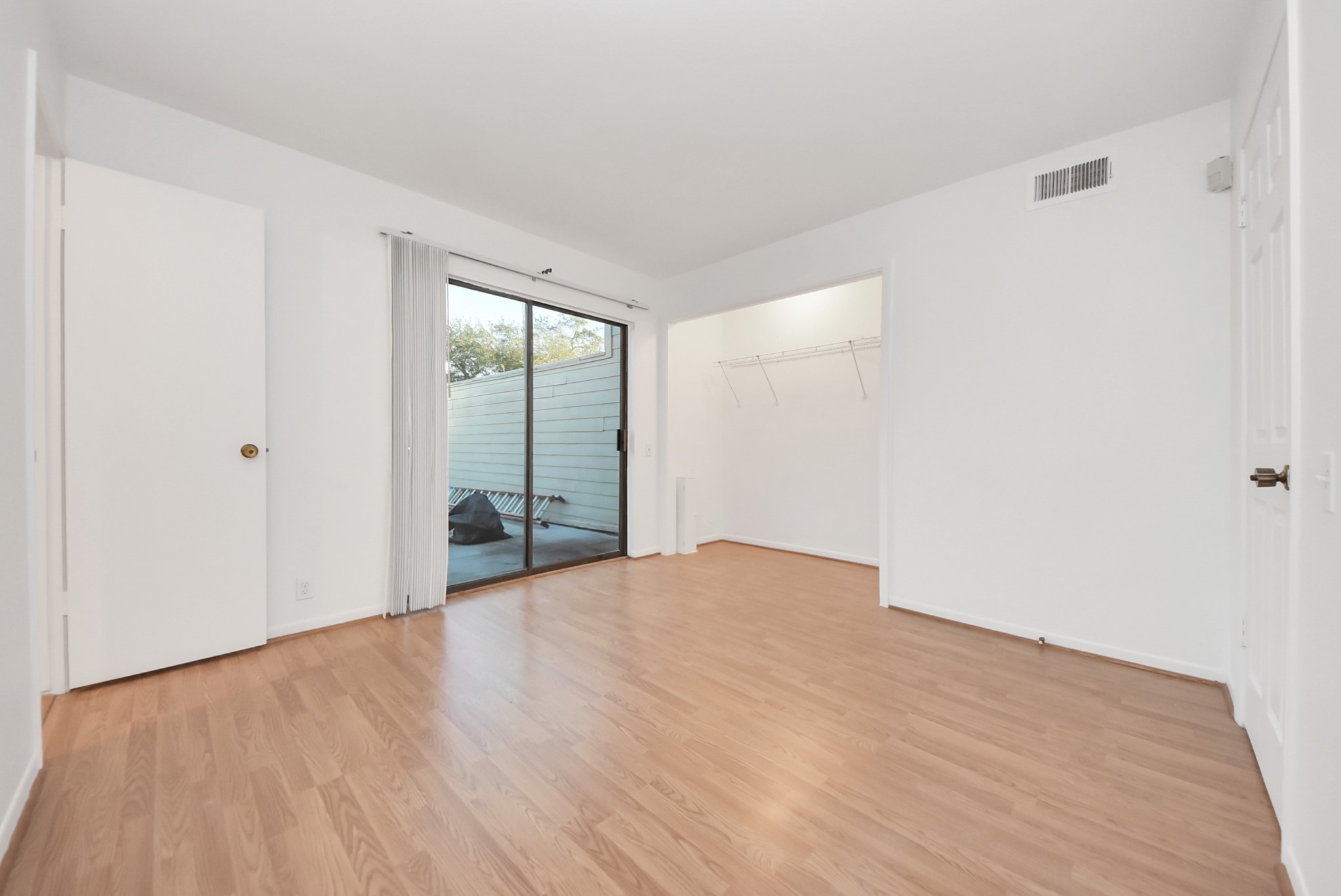 1635 Prairie Mark Lane Houston, TX 77077 - Photo 9 of 32 a view of an empty room with wooden floor and a window