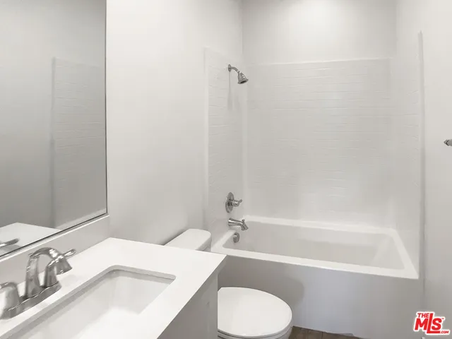 a bathroom with a sink a toilet and bathtub