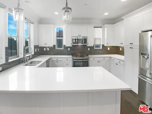 a large kitchen with stainless steel appliances