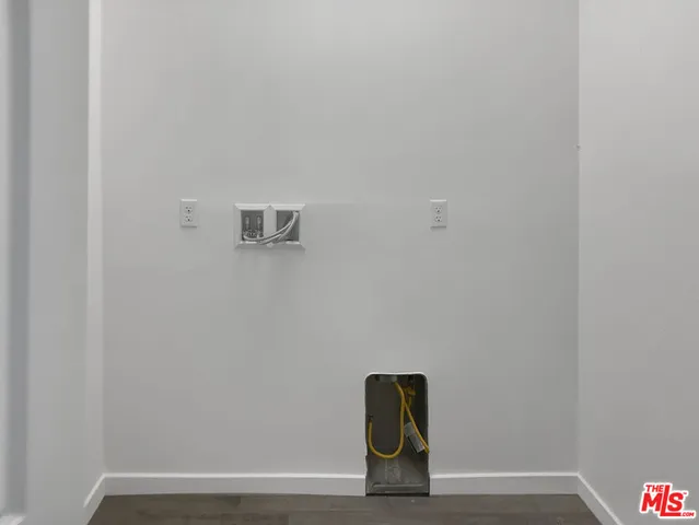 a view of a storage & utility room with two washing machine