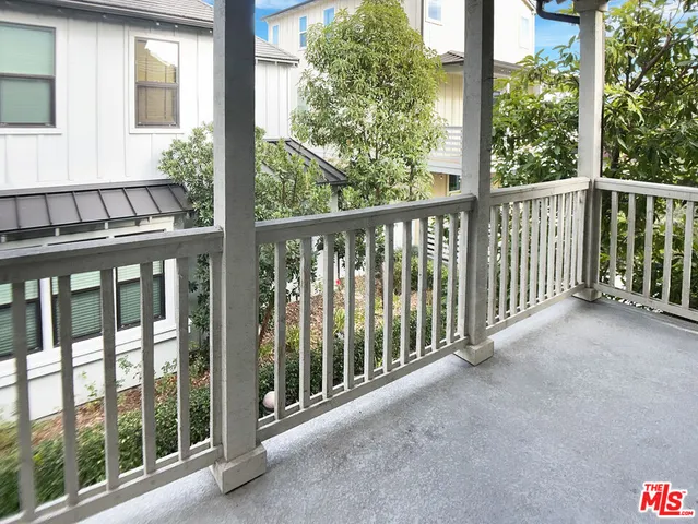 a view of a balcony with wooden floor
