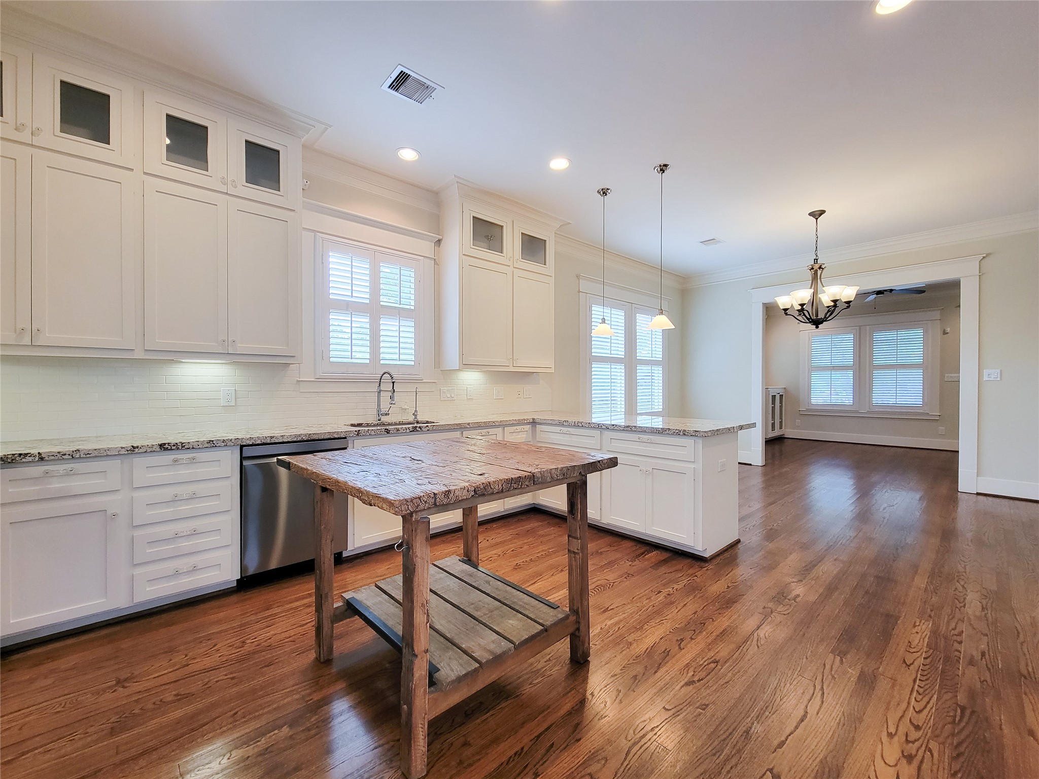 1140 West Cottage Street Houston, TX 77009 - Photo 16 of 37 a kitchen with granite countertop wooden floors and wooden floors