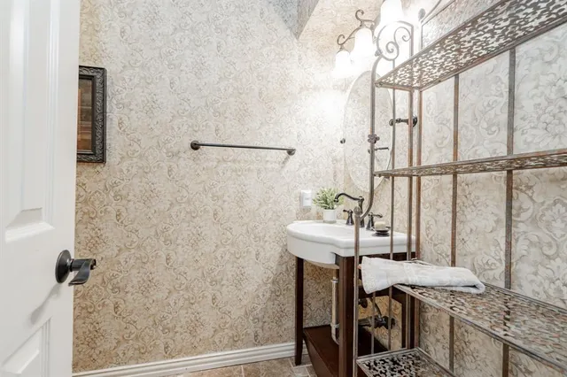 a bathroom with a sink a mirror and a shower