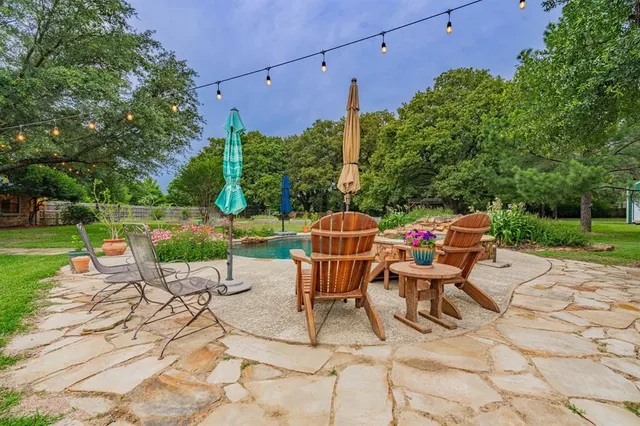 a view of yard with seating area and trees around