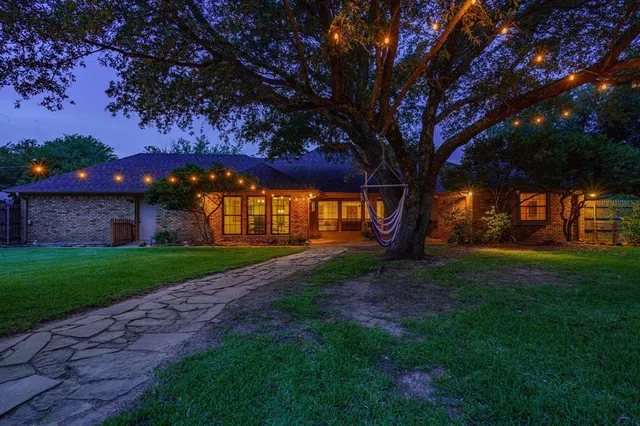 a view of a backyard with large trees