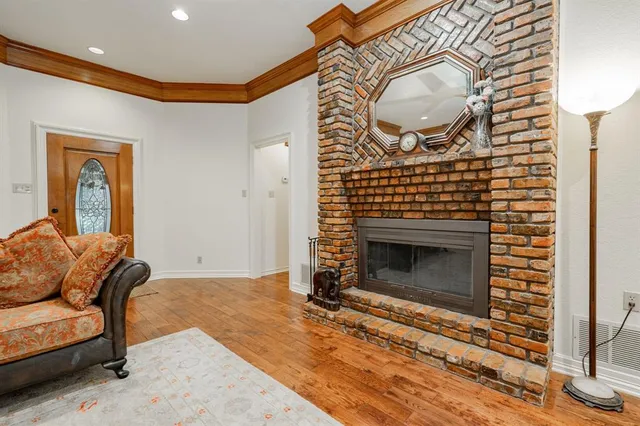 a living room with furniture a mirror and a fireplace