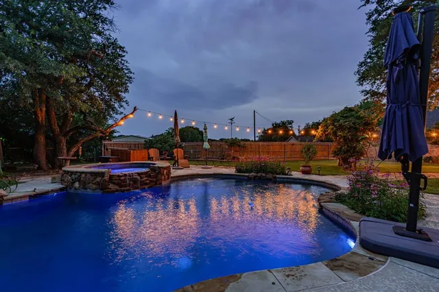 a small pool with lawn chairs and a fire pit