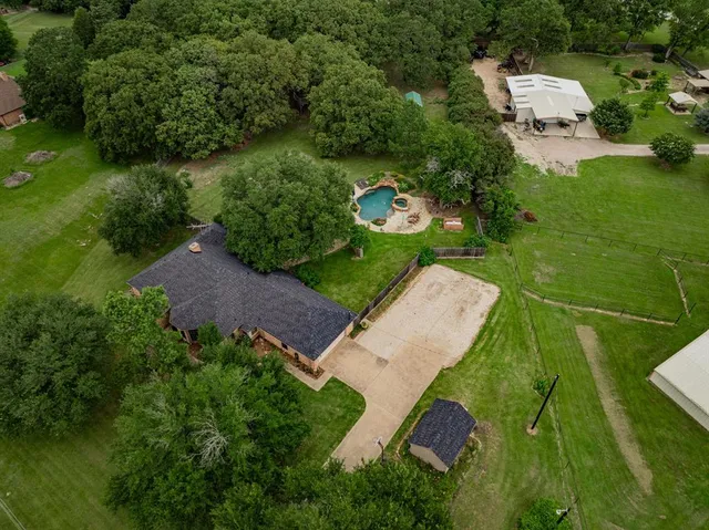 an aerial view of a house with a yard