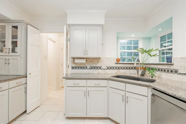 a kitchen with white cabinets and a sink