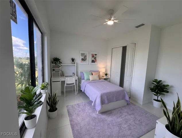 a bedroom with a bed potted plant with the outer view