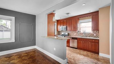 104-28 201st Street Queens, NY 11412 - Photo 3 of 13 Kitchen with stainless steel appliances, healthy amount of natural light, decorative backsplash, and a peninsula