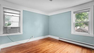 104-28 201st Street Queens, NY 11412 - Photo 7 of 13 Unfurnished room with baseboard heating, cooling unit, and wood finished floors