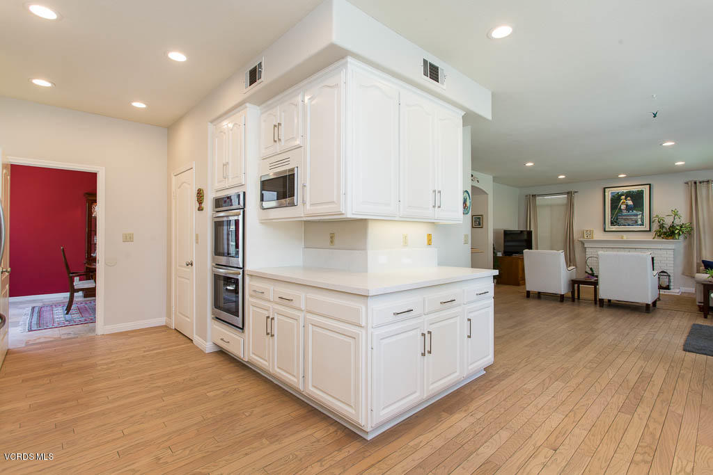11691 Pinedale Road Moorpark, CA 93021 - Photo 13 of 37 a kitchen with stainless steel appliances white cabinets and wooden floors