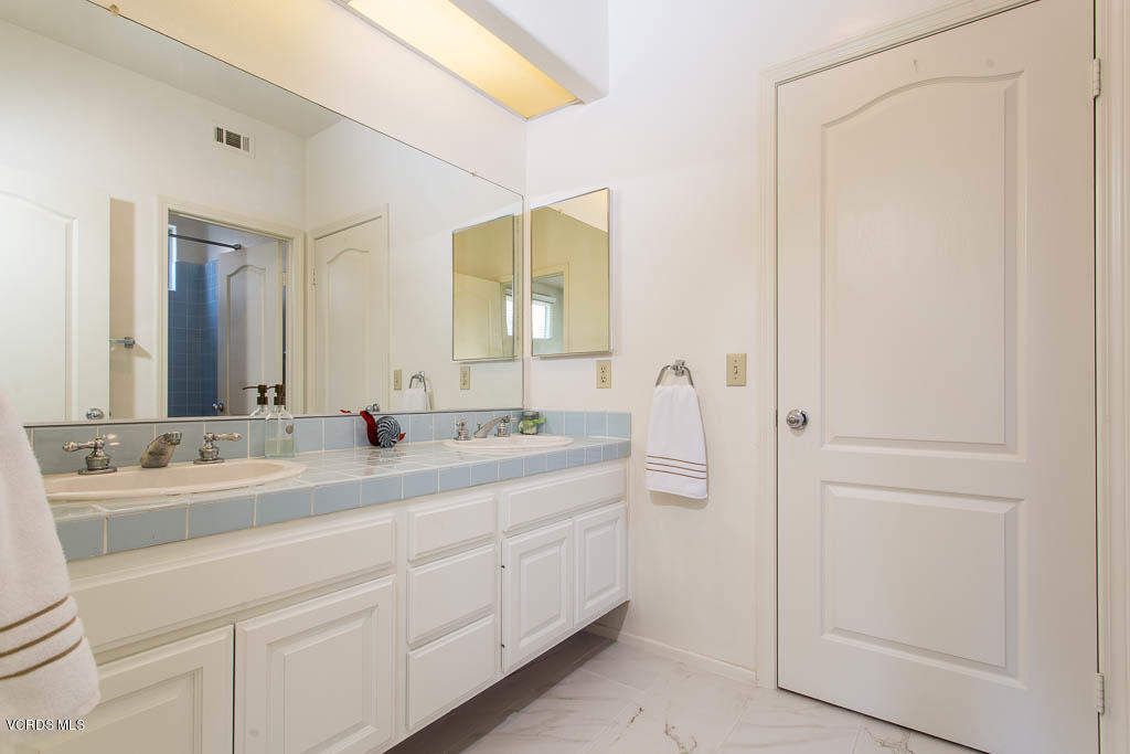 11691 Pinedale Road Moorpark, CA 93021 - Photo 23 of 37 a bathroom with a double vanity sink and mirror