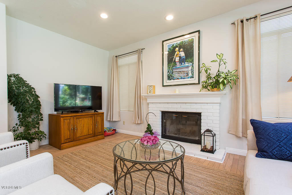 11691 Pinedale Road Moorpark, CA 93021 - Photo 9 of 37 a living room with furniture a flat screen tv and a fireplace