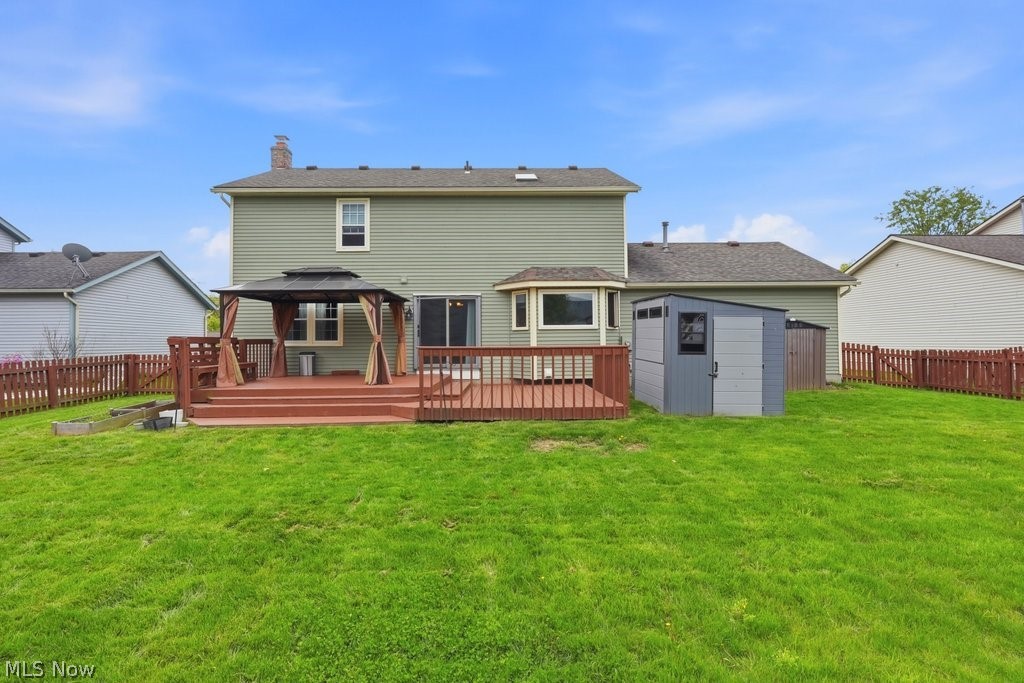 5321 Young Road Stow, OH 44224 - Photo 5 of 37 Expansive green lawn with a multi-level wood deck, featuring a gazebo with drapes