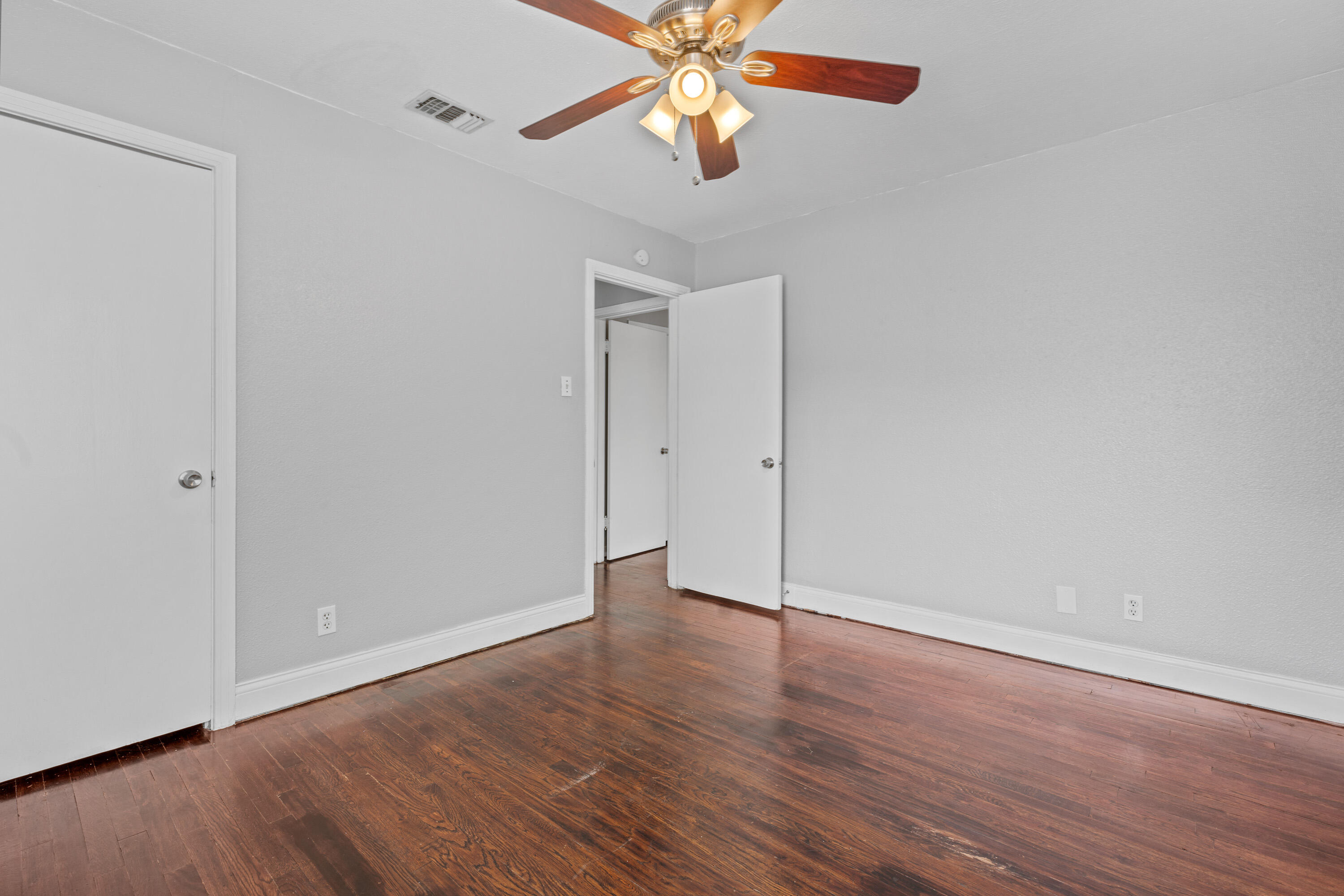 3313 26th Street Lubbock, TX 79410 - Photo 11 of 21 a view of an empty room with wooden floor