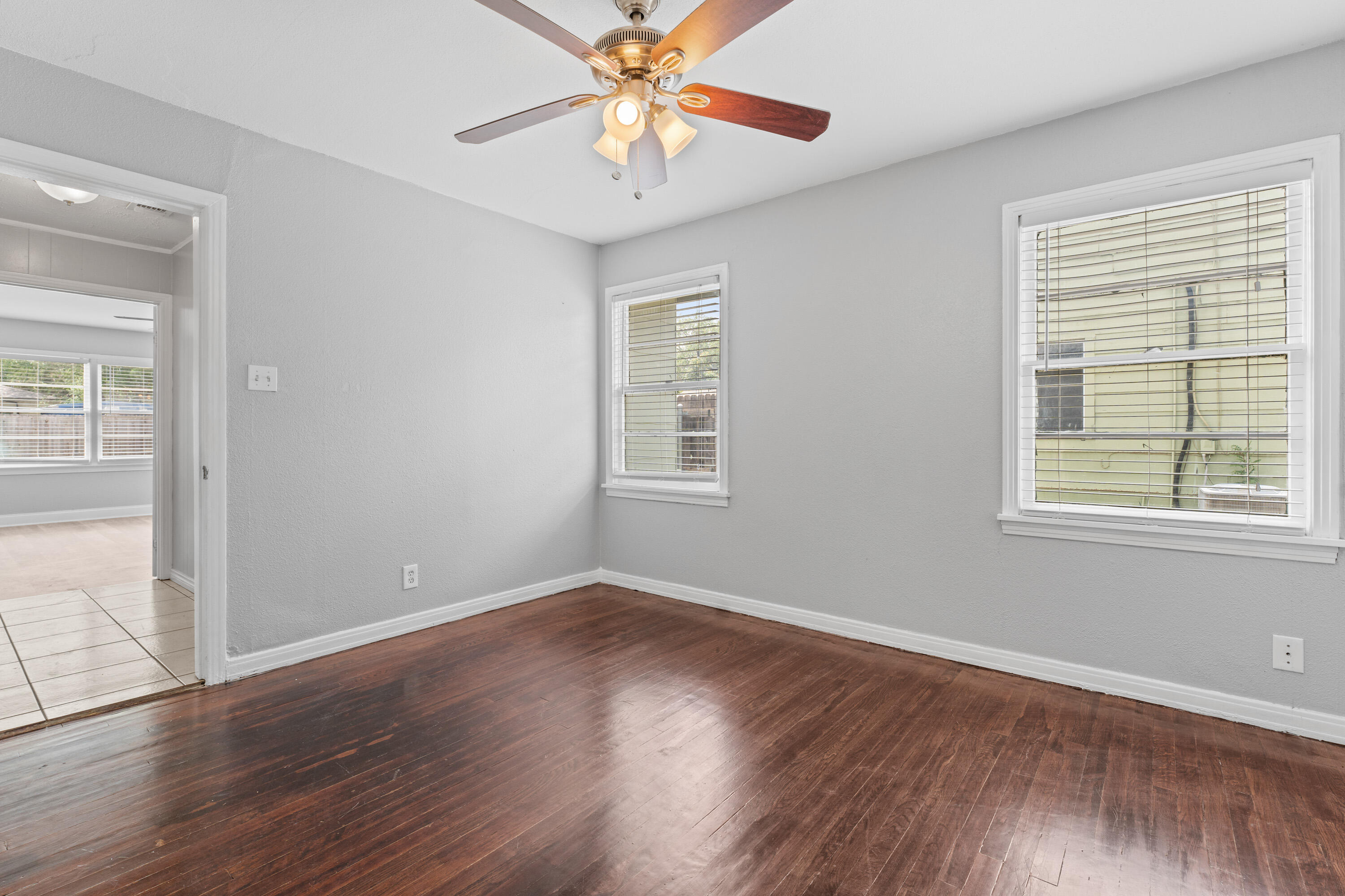 3313 26th Street Lubbock, TX 79410 - Photo 13 of 21 a view of an empty room with wooden floor and a window