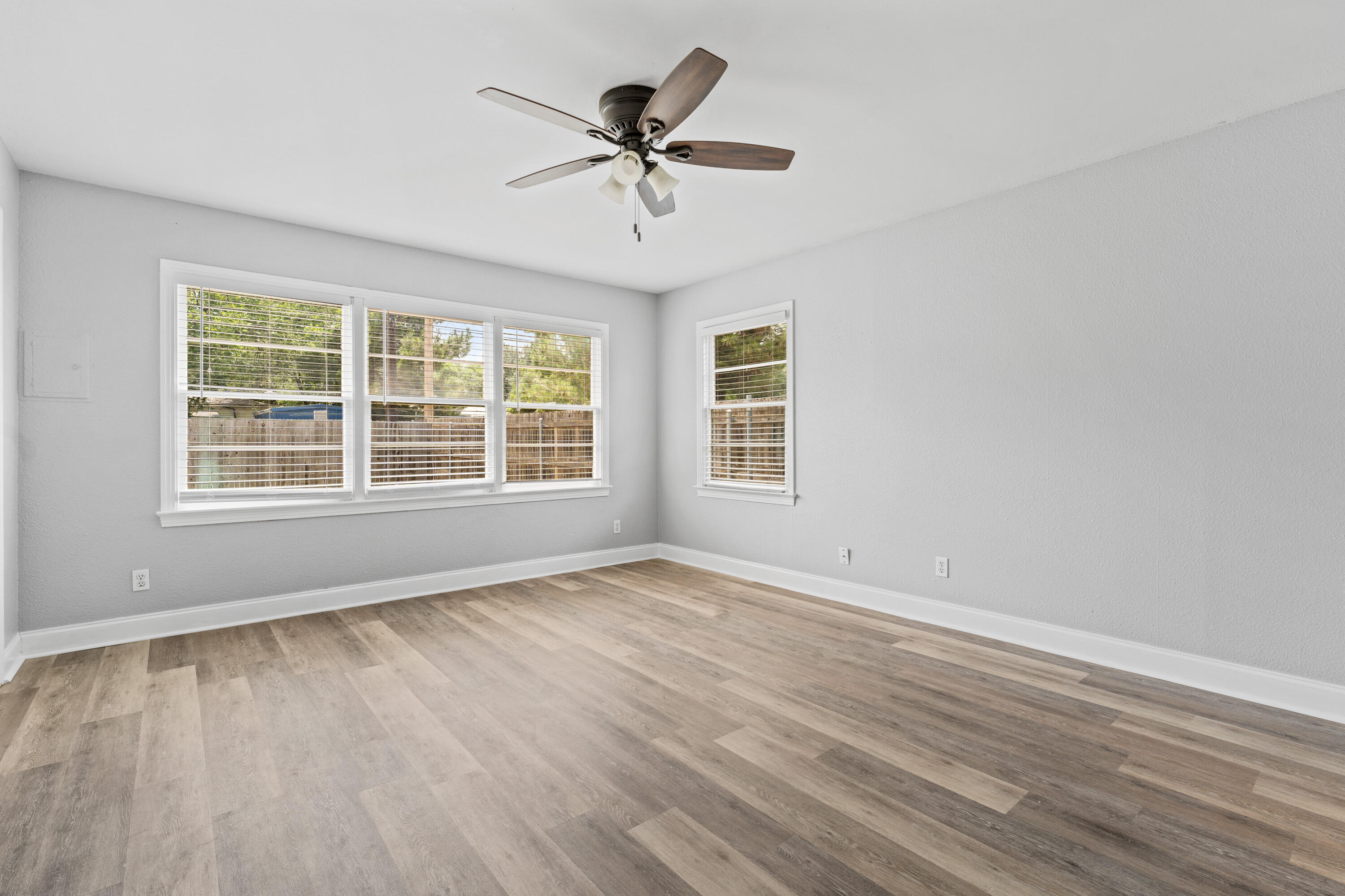3313 26th Street Lubbock, TX 79410 - Photo 15 of 21 an empty room with wooden floor and windows